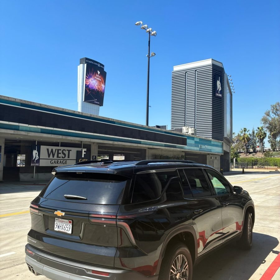 JM Transportation Service - Black 2026 Chevrolet Traverse rear view in urban parking area for luxury private car service Los Angeles