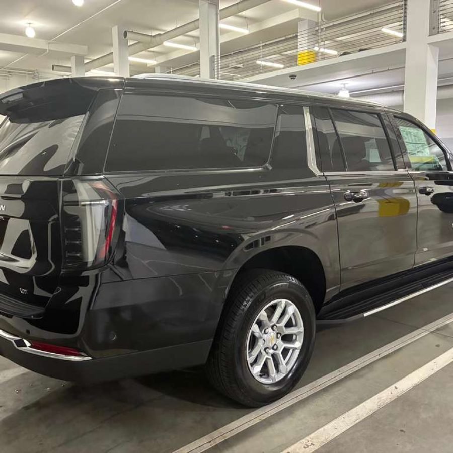 JM Transportation Service - 2025 Black Chevrolet Suburban Rear Side View in Parking